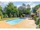 Beautiful backyard featuring a sparkling in-ground pool, patio area, and lush green landscaping at 219 Reese Wilson Rd, Belmont, NC 28012