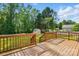 Wooden back deck overlooking a green lawn and mature trees; a great place to relax at 2379 Whitley Rd, Fort Mill, SC 29708