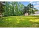 Lawn features a wooden shed, mature trees, and expansive green space for recreation at 2379 Whitley Rd, Fort Mill, SC 29708