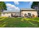 Home backyard features a well-manicured lawn, mature trees, and a wooden deck at 2379 Whitley Rd, Fort Mill, SC 29708