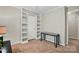 Bedroom featuring neutral walls, carpet, built-in shelving, a dark accent table and natural lighting creating a calming space at 2379 Whitley Rd, Fort Mill, SC 29708