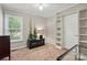A cozy bedroom with neutral walls, carpet, built in shelving, and natural light creating a relaxing atmosphere at 2379 Whitley Rd, Fort Mill, SC 29708