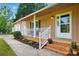 Close-up of a charming front porch with white railing, fresh flowers, and brick steps at 2379 Whitley Rd, Fort Mill, SC 29708