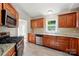 Modern kitchen with stainless steel appliances, granite countertops, and natural wood cabinetry at 2379 Whitley Rd, Fort Mill, SC 29708