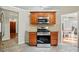 A kitchen with wooden cabinets, stainless steel oven and microwave, tile backsplash, and view to the entry and dining room at 2379 Whitley Rd, Fort Mill, SC 29708