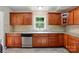 A well-lit kitchen featuring wooden cabinets, stainless steel appliances, granite countertops, and a neutral tile backsplash at 2379 Whitley Rd, Fort Mill, SC 29708