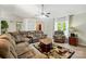 Comfortable living room featuring a large sectional sofa, built in bookcases, ceiling fan, and natural light at 2379 Whitley Rd, Fort Mill, SC 29708