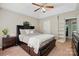 Main bedroom offers a ceiling fan, large bed, side tables, neutral walls, carpet, and built-in shelving for plenty of storage at 2379 Whitley Rd, Fort Mill, SC 29708