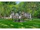 Picturesque backyard with a fire pit surrounded by Adirondack chairs, perfect for outdoor gatherings at 2500 Little Cove Rd, Charlotte, NC 28270