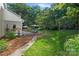 Serene backyard featuring a wooden deck, comfortable seating, and lush landscaping at 2500 Little Cove Rd, Charlotte, NC 28270