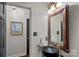 Stylish powder room with a vessel sink, decorative mirror, and modern lighting at 2500 Little Cove Rd, Charlotte, NC 28270