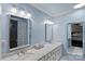 Well-lit bathroom with dual sinks, marble countertops, and modern fixtures at 2500 Little Cove Rd, Charlotte, NC 28270