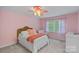 Pink bedroom features a charming bed with a ruffled bed skirt and a decorative ceiling fan at 2500 Little Cove Rd, Charlotte, NC 28270