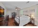 Comfortable bedroom featuring a classic bed frame, hardwood floors, and ample natural light at 2500 Little Cove Rd, Charlotte, NC 28270