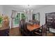 Inviting dining room with a large window, dark wood table, chairs, and hardwood floors at 2500 Little Cove Rd, Charlotte, NC 28270