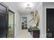 Inviting foyer with tiled floor, decorative mirror, chandelier, and staircase at 2500 Little Cove Rd, Charlotte, NC 28270