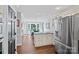 Bright kitchen with a refrigerator, an island, and an open view to the dining area at 2500 Little Cove Rd, Charlotte, NC 28270