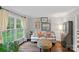 Bright living room showcasing a comfortable sofa, stylish ottoman, and curated artwork on the walls at 2500 Little Cove Rd, Charlotte, NC 28270