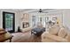 Cozy living room featuring a white brick fireplace, beamed ceilings, and hardwood floors at 2500 Little Cove Rd, Charlotte, NC 28270
