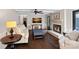 Comfortable living room featuring a fireplace, hardwood floors, and ample seating at 2500 Little Cove Rd, Charlotte, NC 28270