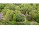 Expansive aerial view showing the home surrounded by lush greenery, mature trees and winding roads in a well-maintained neighborhood at 2600 Oakmeade Dr, Charlotte, NC 28270
