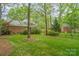 Lush backyard showcasing mature trees and well-maintained lawn, enhancing the home's curb appeal and outdoor living space at 2600 Oakmeade Dr, Charlotte, NC 28270