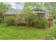 Charming backyard with mature landscaping, multi-level deck, and screened-in porch, creating a private outdoor oasis at 2600 Oakmeade Dr, Charlotte, NC 28270
