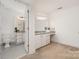 Bathroom featuring dual vanities with granite counters and a separate makeup vanity area at 2600 Oakmeade Dr, Charlotte, NC 28270