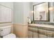 Charming powder room with decorative mirror, soft lighting, and custom sink, adding a touch of elegance at 2600 Oakmeade Dr, Charlotte, NC 28270