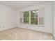 Bedroom featuring a large window overlooking the greenery outside at 2600 Oakmeade Dr, Charlotte, NC 28270