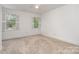 Bright bedroom featuring two large windows and neutral carpet flooring at 2600 Oakmeade Dr, Charlotte, NC 28270