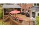 Multi-level deck boasts stylish outdoor furniture, covered porch access, and verdant yard views, perfect for entertaining and grilling at 2600 Oakmeade Dr, Charlotte, NC 28270