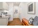 Welcoming entryway featuring hardwood floors, bench seating, and a convenient desk area, combining style and functionality at 2600 Oakmeade Dr, Charlotte, NC 28270