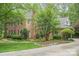 Well maintained brick home with flower beds, manicured lawn, mature trees and long driveway at 2600 Oakmeade Dr, Charlotte, NC 28270