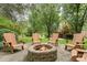 Inviting outdoor firepit area with Adirondack chairs set on a stone patio, perfect for gatherings and cozy evenings at 2600 Oakmeade Dr, Charlotte, NC 28270