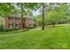Beautiful brick home with lush green lawn, mature trees, and well-maintained landscaping at 2600 Oakmeade Dr, Charlotte, NC 28270