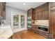 Stylish kitchen featuring stainless steel appliances, wood cabinets, granite countertops, and a view to outdoor patio at 2600 Oakmeade Dr, Charlotte, NC 28270
