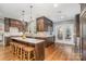 Spacious kitchen with dark wood cabinets, granite counters, and island with seating, ideal for entertaining at 2600 Oakmeade Dr, Charlotte, NC 28270