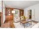 Bright living room featuring custom built-in shelves, a cozy armchair, and a large coffee table for relaxing moments at 2600 Oakmeade Dr, Charlotte, NC 28270