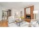 Inviting living room featuring a brick fireplace, hardwood floors, and plenty of natural light for cozy gatherings at 2600 Oakmeade Dr, Charlotte, NC 28270