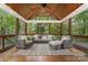 Inviting covered porch features a ceiling fan, wood plank ceiling, and comfortable seating area, perfect for relaxing outdoors at 2600 Oakmeade Dr, Charlotte, NC 28270