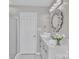 Bright bathroom with a marble countertop, decorative mirror, and glass enclosed shower at 3127 Ocalle Ln, Indian Land, SC 29707
