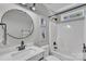 Clean bathroom with a round mirror, neutral colored walls, and a tub with shower at 3127 Ocalle Ln, Indian Land, SC 29707