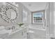 Well-lit bathroom featuring a soaking tub, vanity with marble countertop, and modern fixtures at 3127 Ocalle Ln, Indian Land, SC 29707