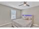 Simple bedroom featuring a ceiling fan, window, and comfortable bed with accent lighting at 3127 Ocalle Ln, Indian Land, SC 29707