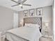 Bedroom featuring a ceiling fan, bedside tables, upholstered headboard, and elegant decor at 3127 Ocalle Ln, Indian Land, SC 29707
