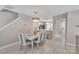 Elegant dining area featuring stylish furniture and a view into the modern kitchen at 3127 Ocalle Ln, Indian Land, SC 29707