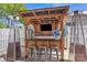 Outdoor bar with a wooden pergola, seating, and bar with a TV, perfect for entertaining at 3127 Ocalle Ln, Indian Land, SC 29707