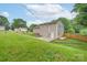 A view of a well maintained yard and the rear elevation of the home in summer at 3219 Spring Valley Dr, Gastonia, NC 28052
