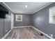 A neutral bedroom offers plenty of space with great natural light and plank flooring at 3219 Spring Valley Dr, Gastonia, NC 28052